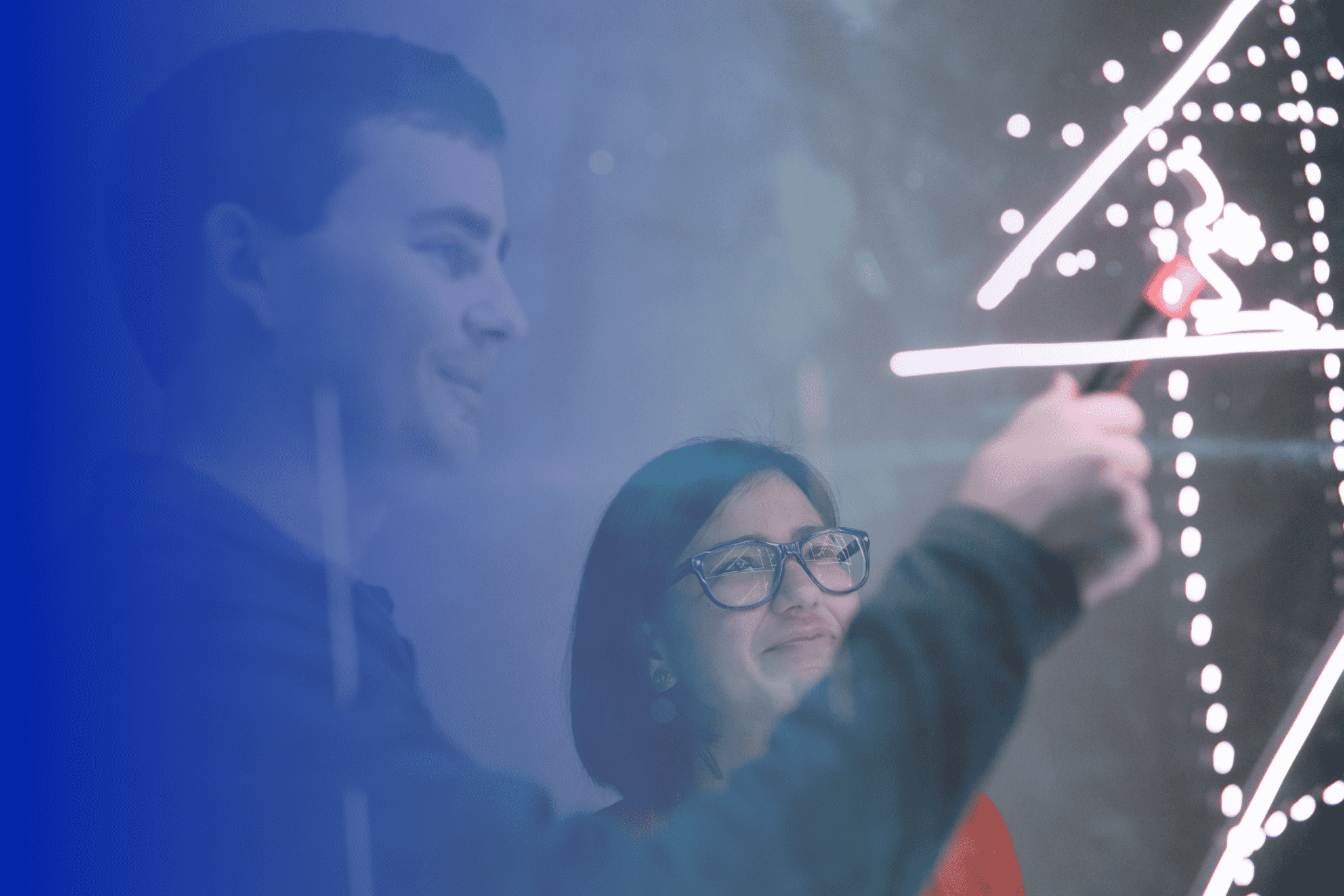 A guy and a lady analyzing data in a board